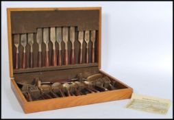 A vintage retro mid 20th century bronze six person canteen of cutlery complete in wooden teak