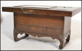 A 20th century Chinese hardwood Hibachi coffee table of low form raised on block supports with
