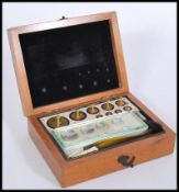 A 19th Century mahogany cased set of graduating Jewellers weights set within the mahogany ivory