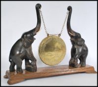 A 1920's Burmese elephant gong. The table top gong with hand beaten brass gong suspended from chains