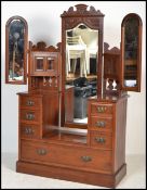 An Edwardian walnut batwing triple mirror dressing table chest of drawers. Raised on a plinth base