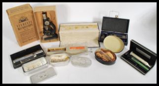 A collection of 20th century doctors items to include boxed glass syringes, a students microscope