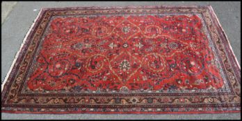 A fine early 20th century Persian rug with red ground being decorated with large medallion and