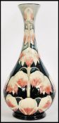 Moorcroft - Anji Davenport. A tall tubelined baluster vase hand decorated and painted in the