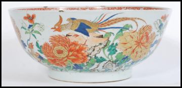 A large 18th / 19th century Chinese famille rose punch / fruit bowl painted with chrysanthemum and