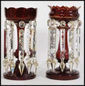 A set of two 19th century Victorian lustres to include a cranberry glass lustre with a scalloped