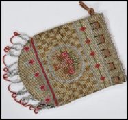 A vintage 1920's steel cut bead work bag having a leather drawstring closure with a floral design
