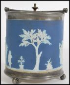 A 20th century blue Jasperware biscuit tin, having raised white detailing depicting fruit pickers on