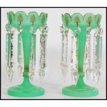 A pair of 19th century Victorian green glass lustres of trumpet form with with scallop detail