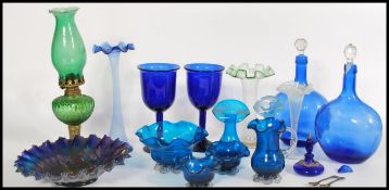 A collection of 19th century Victorian green and blue glass wares to include a green glass and brass