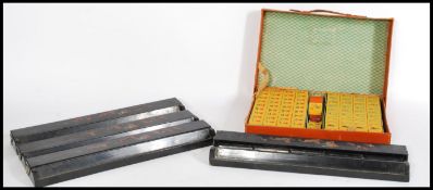 A 20th century Chinese Mahjong set having bakelite / lucite playing pieces and a set of four