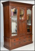 An early 20th Century Edwardian mahogany double / triple wardrobe, with moulded cornice and mirrored