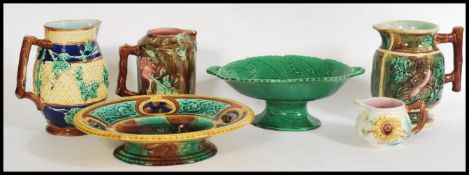 A group of 19th century Victorian Majolica items to include jugs, bread plate, sunflower, cream