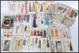 A collection of vintage 20th century sewing patterns of varying designs complete in the packaging