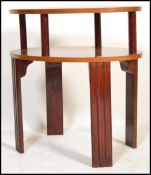 An early 20th Century Art Deco 1930's two tier occasional table, of shaped form having twin tiers on