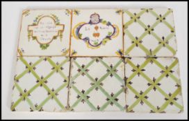 A selection of Victorian faience tiles including two with french inscriptions, and the others having