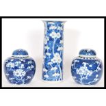 A pair of 20th century Chinese blue and white lidded ginger jars hand painted in the prunus