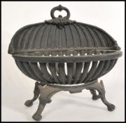 An antique style oval cast iron fire basket. Raised on shaped legs with oval deep basket having
