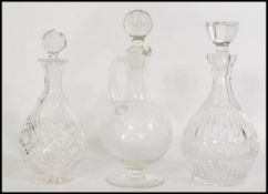 Three cut glass decanters to include two of bulbous from with crystal stoppers, and one jug form