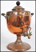 A Victorian copper and brass twin handled samovar complete with the tap to front having a rococo