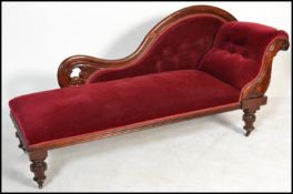 A Victorian mahogany chaise longue / day bed being raised on turned legs with show wood frame,