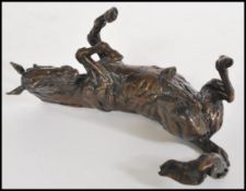 A bronze figurine of a horse reclining by Lucy Kinsella, signed to the base 'Kinsella' marked A/P L.