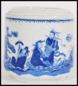 A 19th century Chinese blue and white brush pot having hand painted scenes depicting immortal elders