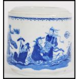 A 19th century Chinese blue and white brush pot having hand painted scenes depicting immortal elders