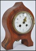 A 19th Century walnut cased eight day spire shaped mantel clock, the enamel face with gilt hands,