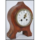A 19th Century walnut cased eight day spire shaped mantel clock, the enamel face with gilt hands,