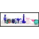 A good collection of Bristol Blue glass to include decanters, glasses in blue and cranberry glass,