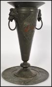 A 19th century pewter classical urn with stand in the antique taste of trumpet form, having twin