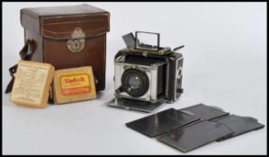 An early 20th century Ernemann Klapp Camera in leather box marked for Sands Hunter & Co. Brass doors