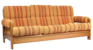 A TEAK AND TEXTURED WEAVE SOFA DAYBED BY C. D. PIERCE & SON LTD