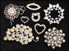 A collection of 1950s white metal brooches set with rhinestones. x8 Largest measures 3 inches,
