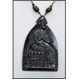 A 1930s Czech Neiger brothers Egyptian revival glass pendant necklace strung with black and red/