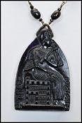 A 1930s Czech Neiger brothers Egyptian revival glass pendant necklace strung with black and red/