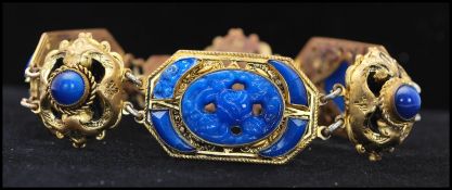 A 1920's Czech gold tone bracelet set with blue art glass signed Made in Czechoslovakia. Measures