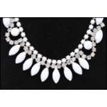 A mid 20th century Czech milk glass and rhinestone necklace and earring set. Measures approx 16