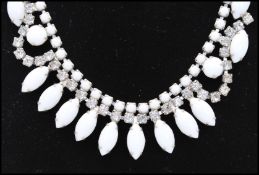 A mid 20th century Czech milk glass and rhinestone necklace and earring set. Measures approx 16