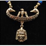 A vintage signed Art © Arthur Pepper gold-tone Egyptian revival pendant necklace. Measures 20 inches