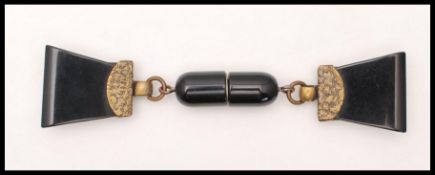 A 1930's Art Deco bakelite cloak / coat / sweater clip fastener having a screw clasp with