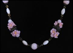 A 1920's vintage Czech pink glass bead flower necklace strung with pink lamp work flowers and