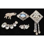 A collection of vintage paste brooches to include an elephant, faux opal and dangle brooch. Largest