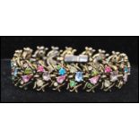 A 1950s signed Hollycraft bracelet set with pastel coloured rhinestones in a foliate setting
