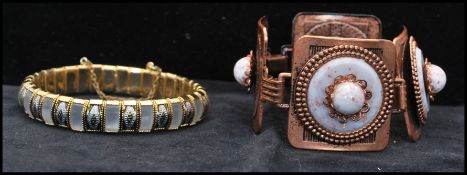A 1950s copper-tone four panel bracelet set with marble thermoset together with a vintage gold-