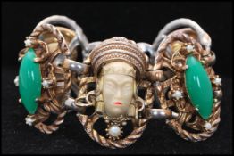 A 1950s Selro Selini Asian princes five link bracelet set with green cabochons and faux pearls.