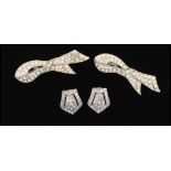 A pair of 1920's white metal paste set dress clips together with a pair of belt clips. Measures -