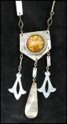 A 1930s Art Deco French silver / white metal and mother of pearl sautoir necklace with ornate art