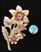 A 1950s oversized gold washed sterling silver flower spray brooch marked Sterling together with a